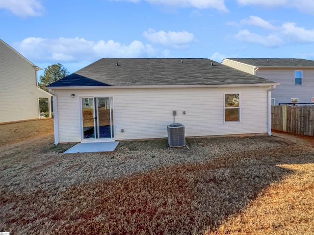 rear view of house with central AC unit and a patio