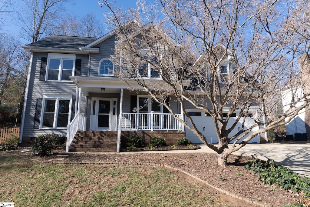 view of front of house featuring covered porch and a garage