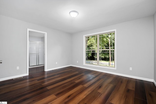 spare room featuring dark hardwood / wood-style flooring