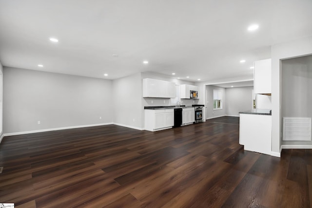 unfurnished living room featuring dark wood-type flooring