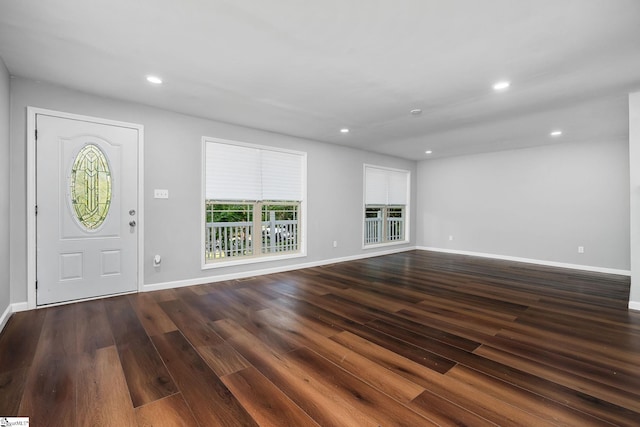 unfurnished living room featuring dark hardwood / wood-style flooring