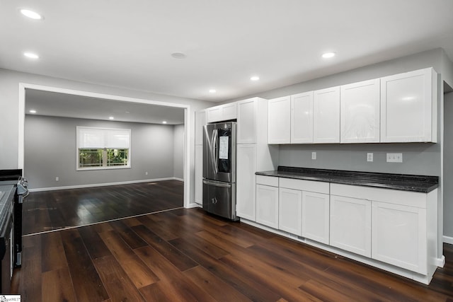 kitchen featuring dark hardwood / wood-style flooring, white cabinets, and stainless steel fridge