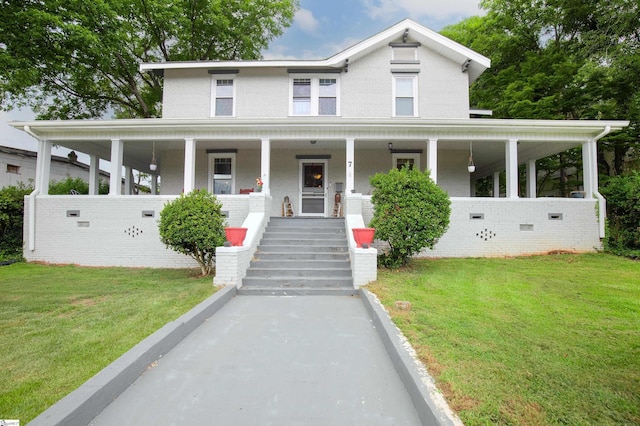 country-style home with a front yard and covered porch