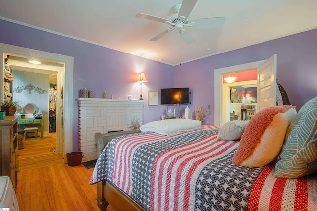 bedroom featuring ceiling fan, light hardwood / wood-style flooring, and ornamental molding