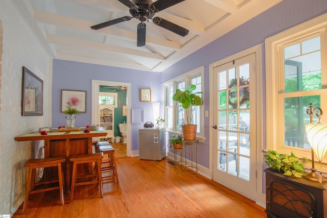 interior space with ceiling fan, light hardwood / wood-style flooring, and vaulted ceiling with beams