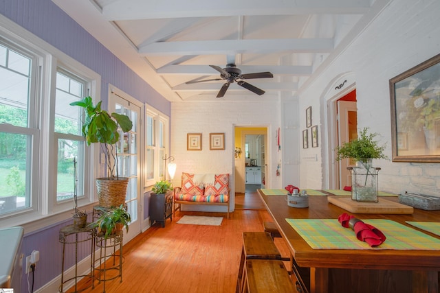 sunroom featuring ceiling fan and vaulted ceiling with beams