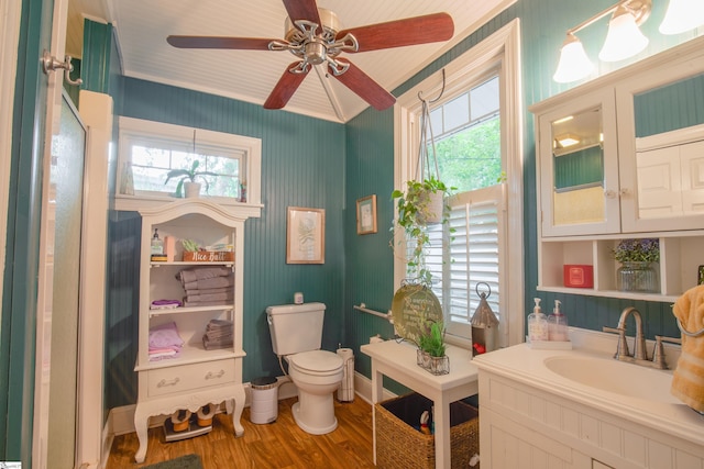 bathroom featuring toilet, crown molding, ceiling fan, wood-type flooring, and vanity