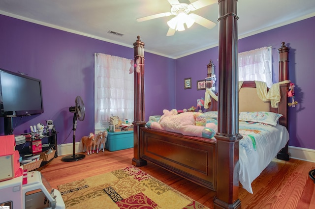 bedroom with ceiling fan, hardwood / wood-style flooring, and crown molding