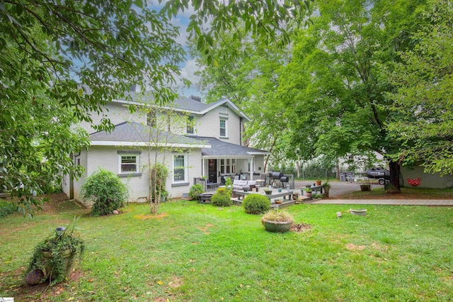 rear view of house featuring an outdoor hangout area and a lawn