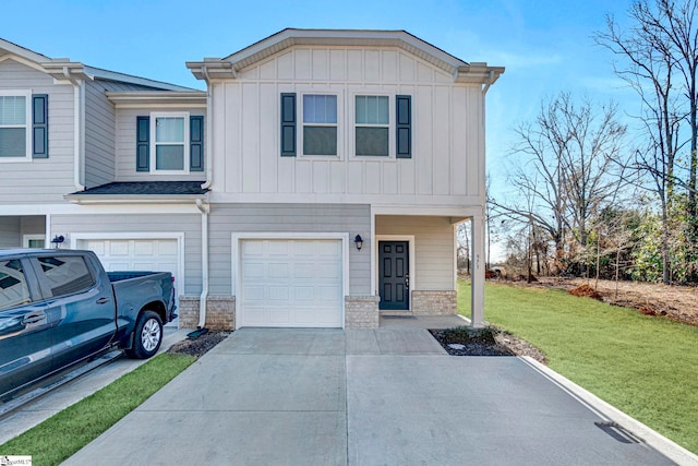 view of front of property featuring a garage and a front lawn