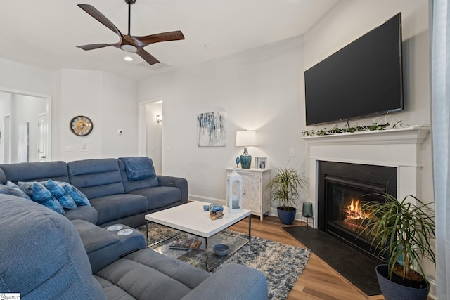 living room with ceiling fan and dark wood-type flooring