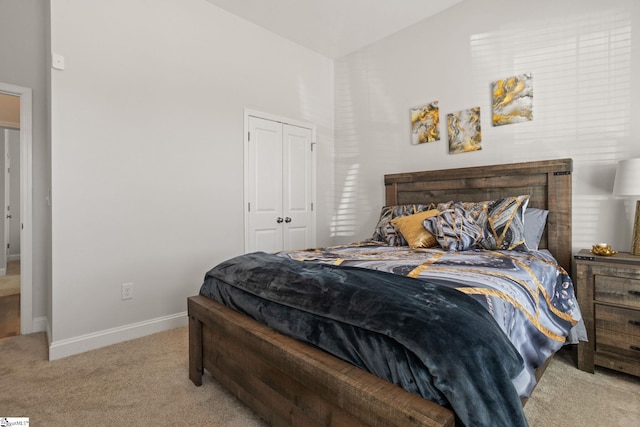 carpeted bedroom featuring a closet and vaulted ceiling