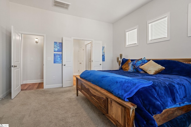 bedroom featuring light colored carpet