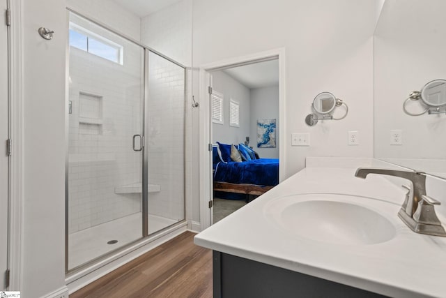 bathroom featuring a shower with door, vanity, and hardwood / wood-style floors