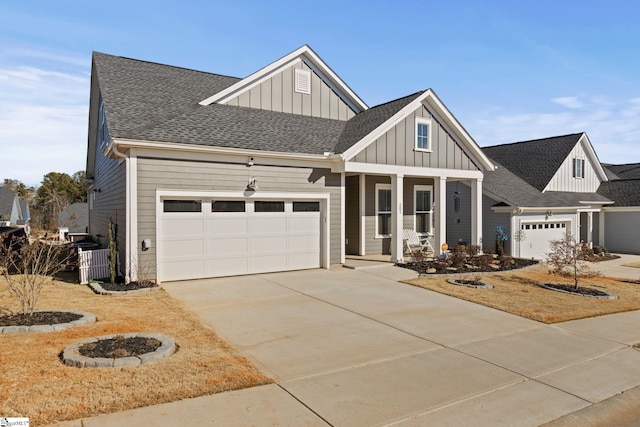 craftsman inspired home with covered porch, cooling unit, and a garage