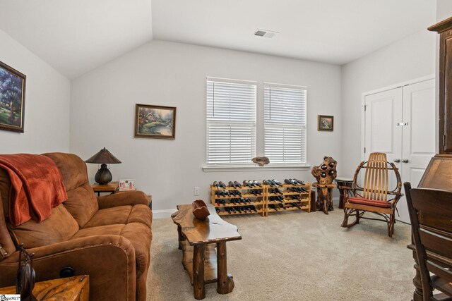 carpeted living room featuring vaulted ceiling