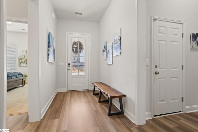 doorway to outside with wood-type flooring