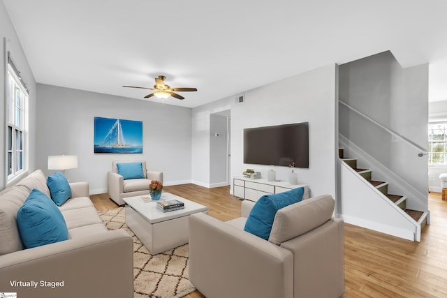 living room with ceiling fan and light hardwood / wood-style floors