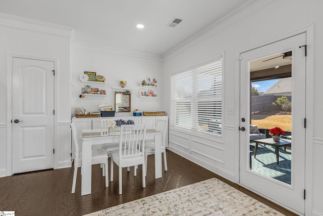 dining room featuring dark hardwood / wood-style flooring and crown molding