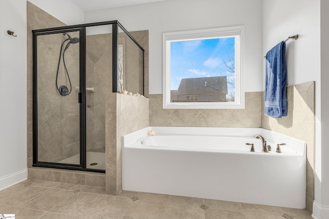 bathroom with tile patterned flooring and independent shower and bath