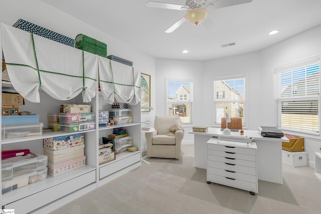 interior space featuring ceiling fan and light colored carpet