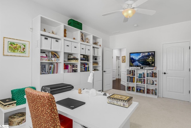 office space featuring ceiling fan and light carpet