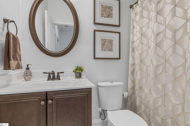 bathroom featuring toilet, curtained shower, and vanity