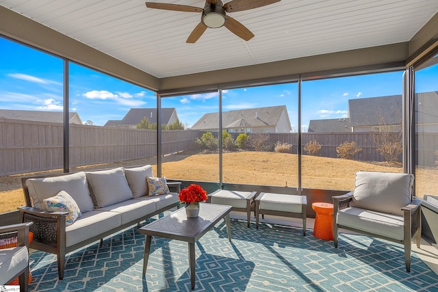 sunroom featuring ceiling fan