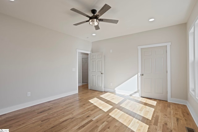 unfurnished bedroom with ceiling fan and light hardwood / wood-style floors