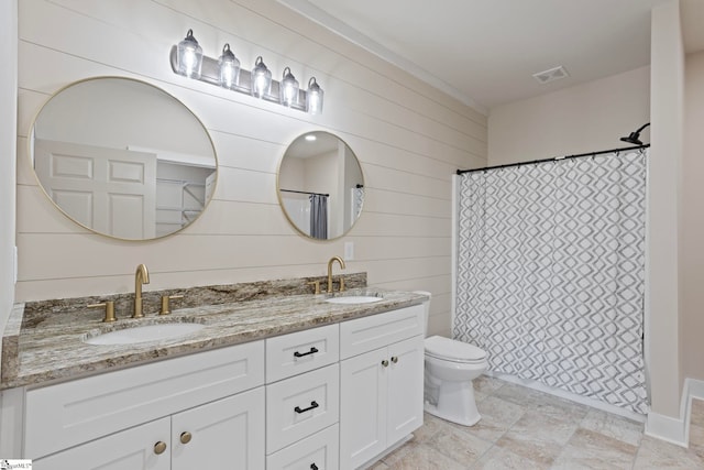 bathroom with walk in shower, wooden walls, vanity, and toilet