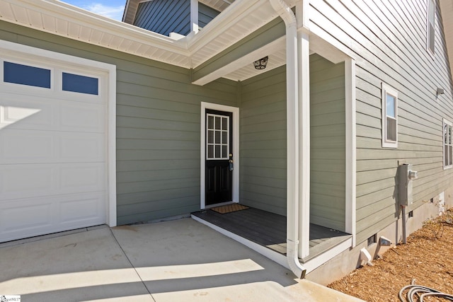 doorway to property with a garage