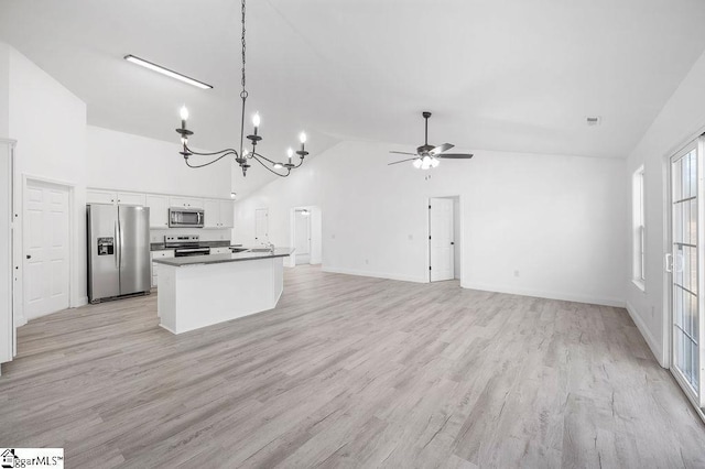 kitchen with ceiling fan with notable chandelier, stainless steel appliances, light hardwood / wood-style floors, and white cabinets