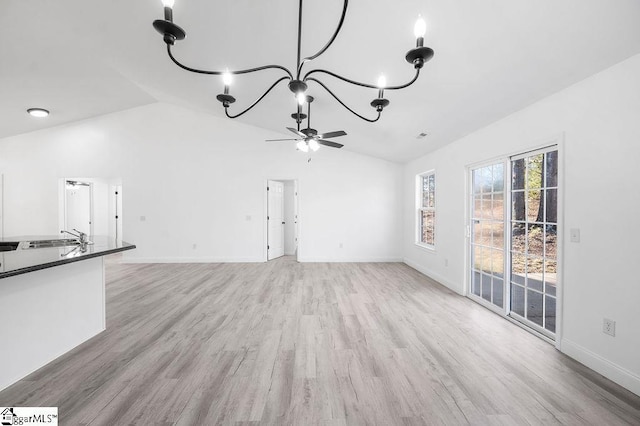 unfurnished living room featuring ceiling fan, light hardwood / wood-style flooring, lofted ceiling, and sink