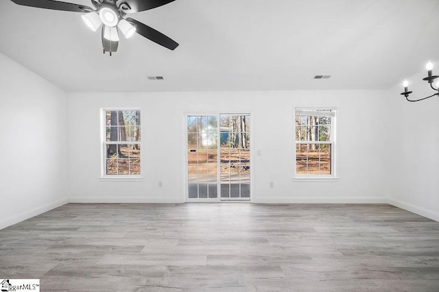 unfurnished room with light hardwood / wood-style floors, ceiling fan, and a healthy amount of sunlight