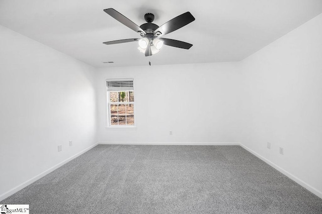 empty room with ceiling fan and carpet flooring