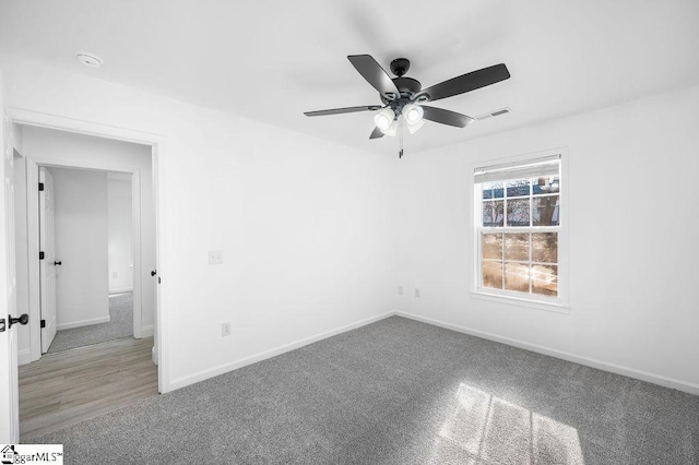 carpeted empty room with ceiling fan