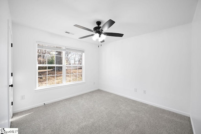 spare room with ceiling fan and carpet