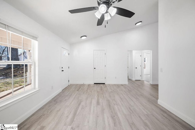 unfurnished room featuring ceiling fan, vaulted ceiling, and light hardwood / wood-style flooring