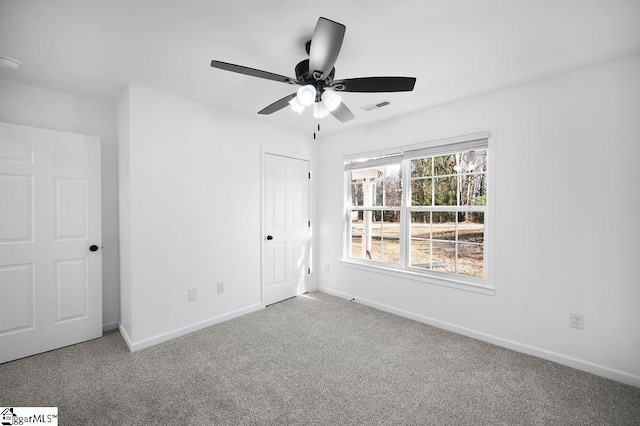 interior space with a closet, ceiling fan, and carpet