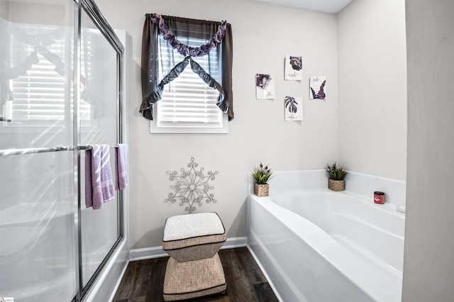 bathroom with hardwood / wood-style flooring and separate shower and tub