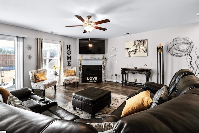 living room featuring ceiling fan and dark wood-type flooring