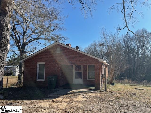 view of side of property with brick siding