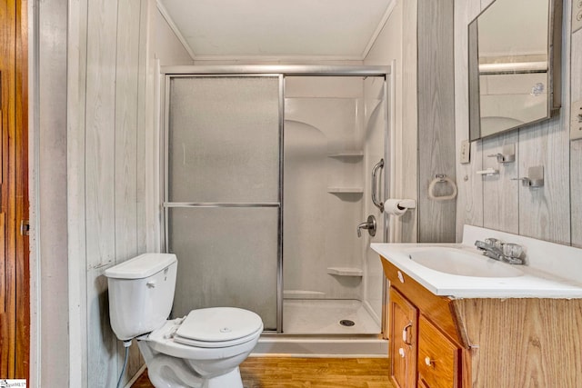 full bathroom with crown molding, a shower stall, toilet, and vanity