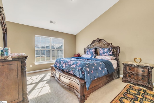 bedroom featuring vaulted ceiling and light carpet