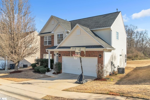 view of front of property with a garage and central AC unit