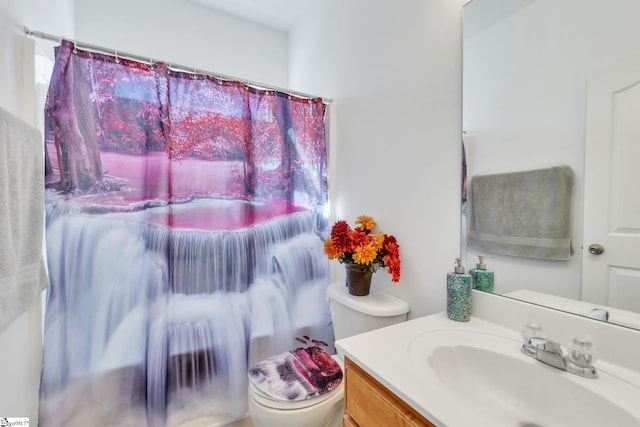 bathroom featuring toilet and vanity