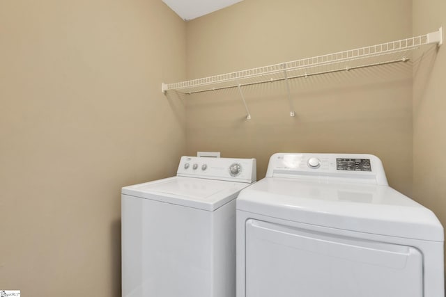 laundry room with independent washer and dryer