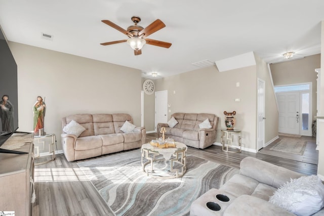 living room featuring wood-type flooring and ceiling fan