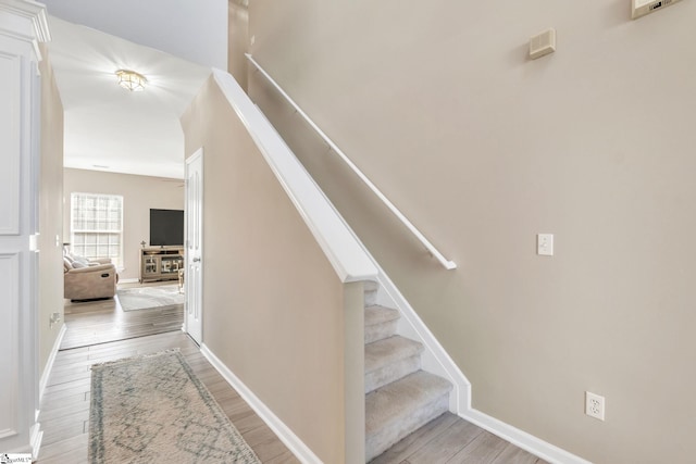 staircase featuring hardwood / wood-style flooring