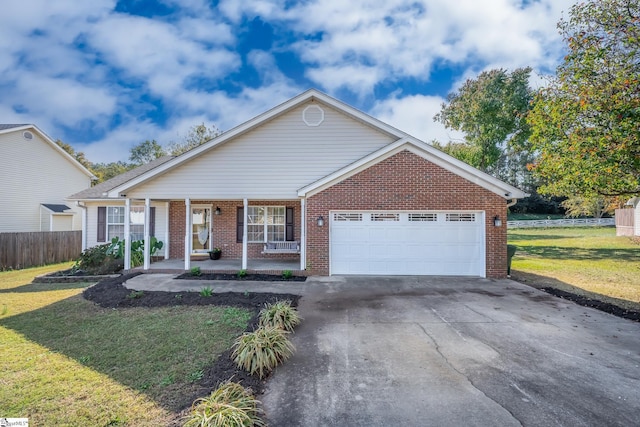 ranch-style home featuring a porch, a front yard, and a garage